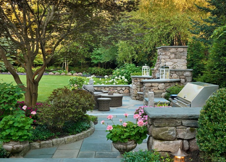 a stone fireplace with a grill and a grill in the background